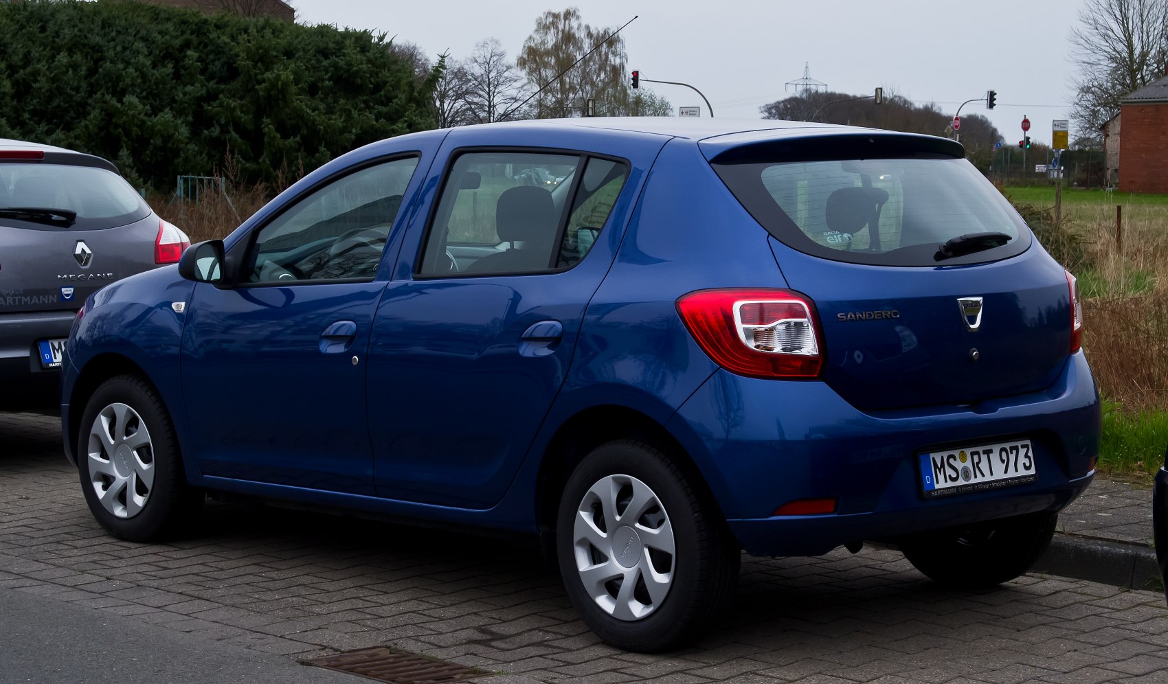 Rear side view of a compact hatchback with distinctive taillights and 5-door design