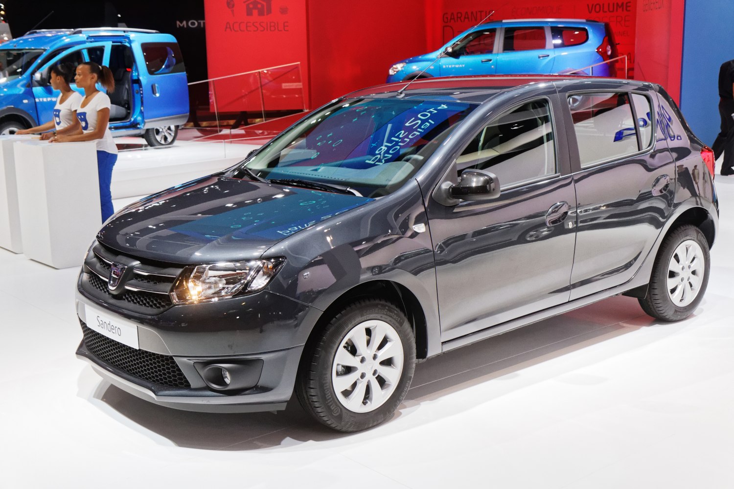 Grey compact hatchback with modern headlights and white alloy wheels