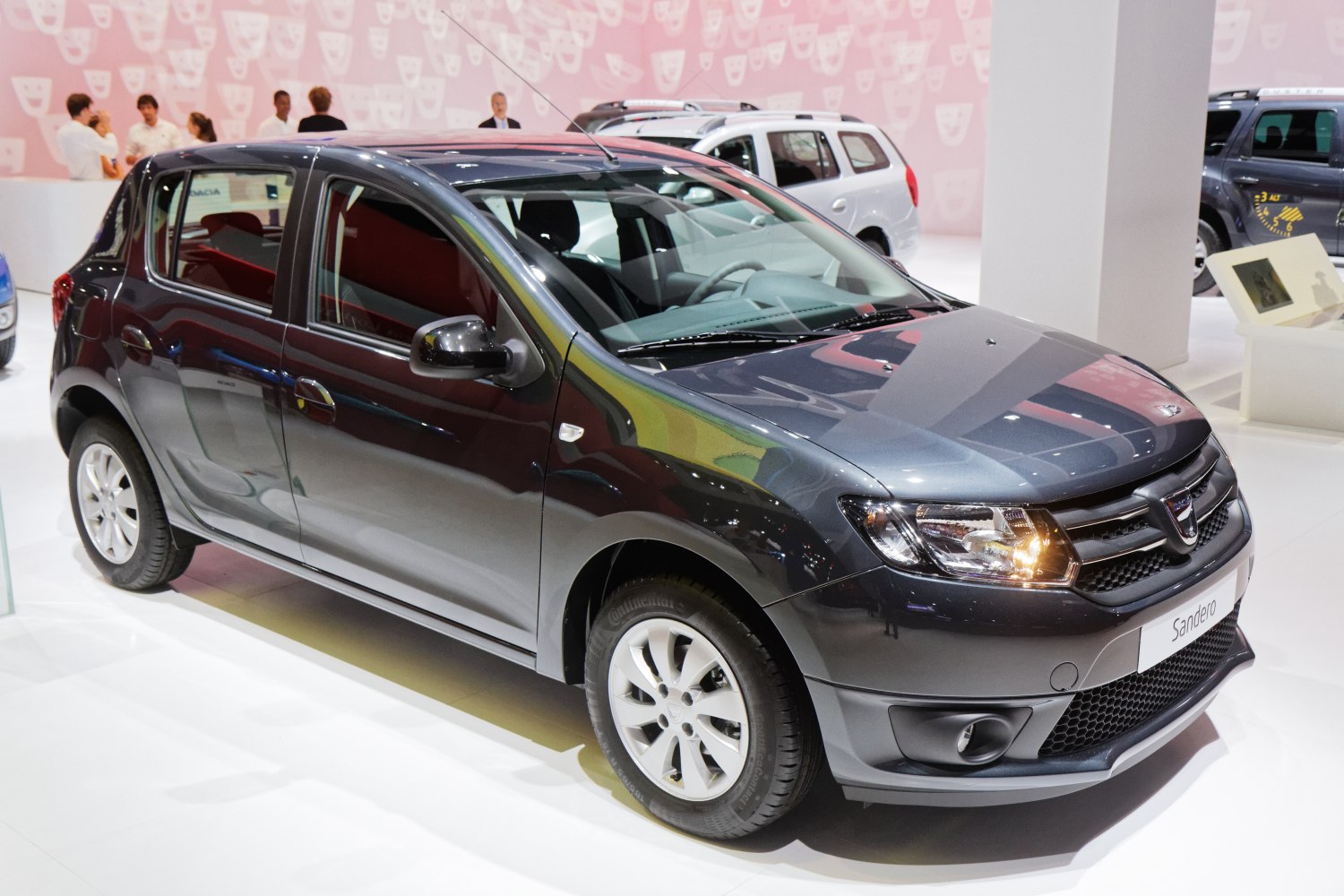 Compact hatchback with prominent headlights and alloy wheels