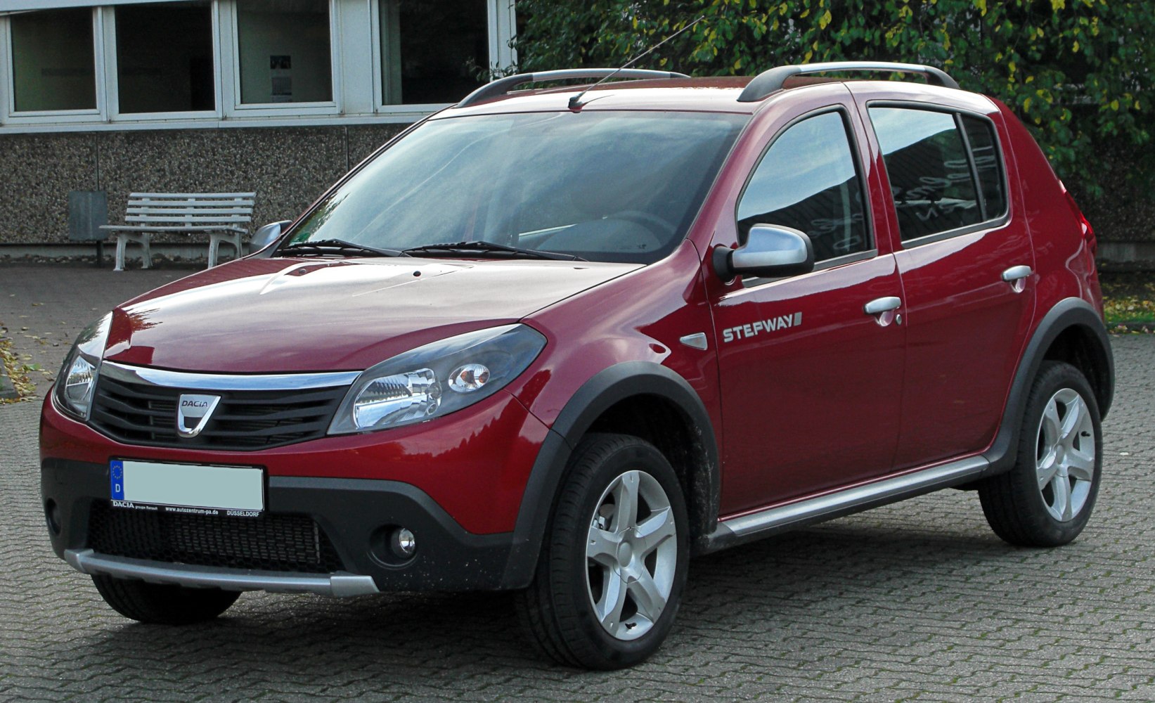 Red hatchback SUV with roof rails and black plastic trims
