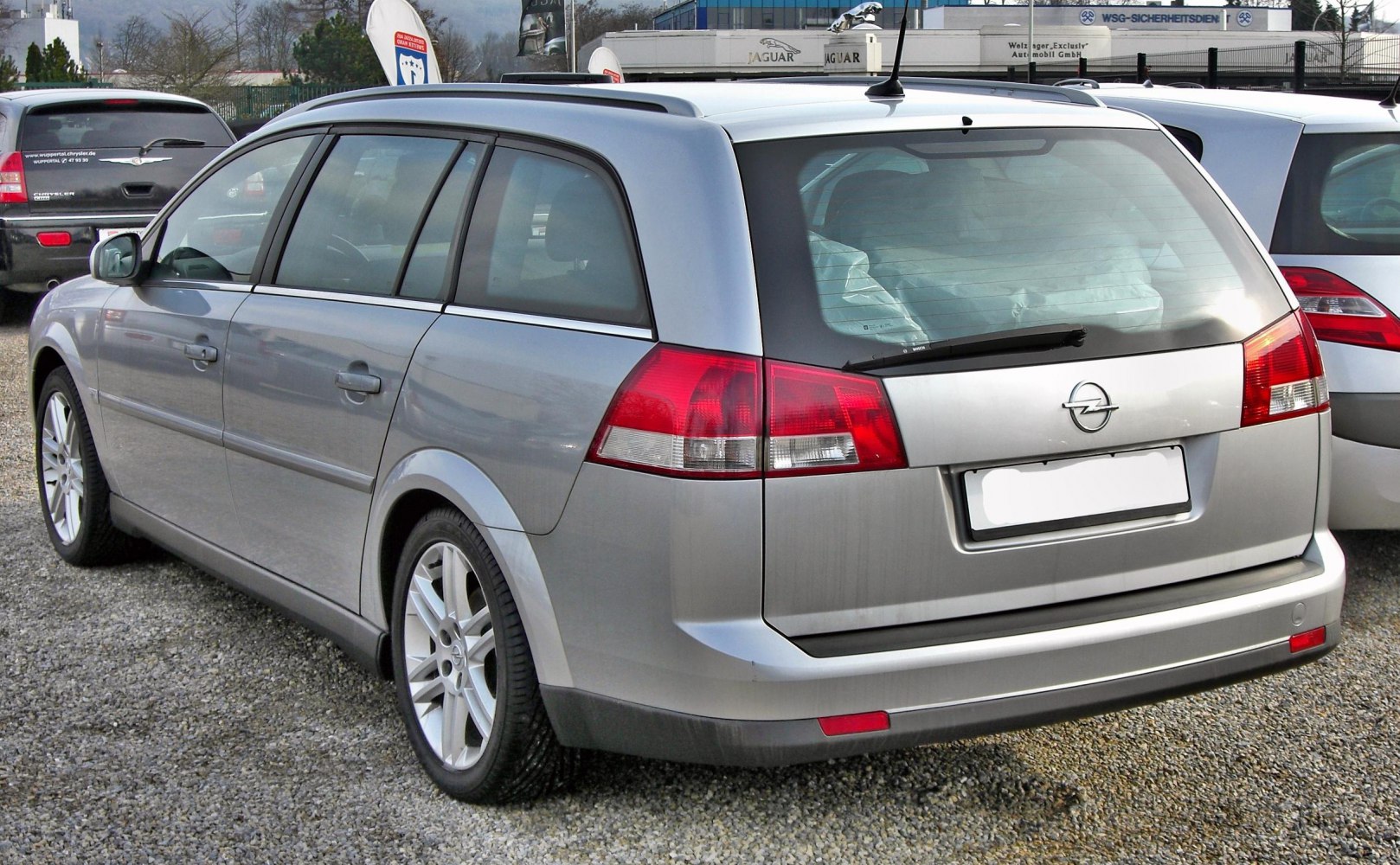 Rear and side view of silver estate station wagon with distinctive taillights