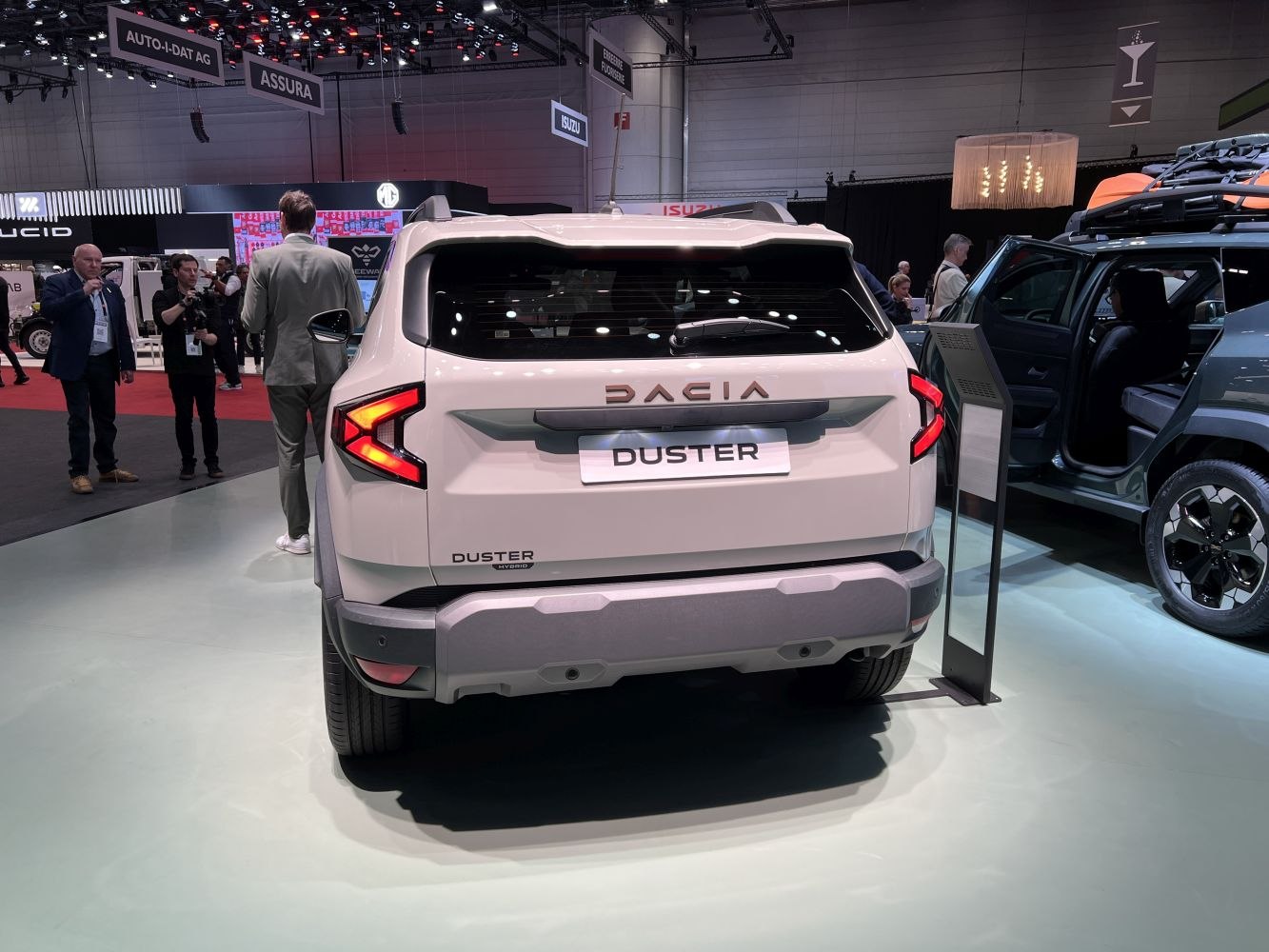 Rear view of a 2024 SUV with distinctive LED tail lights and hybrid badge.