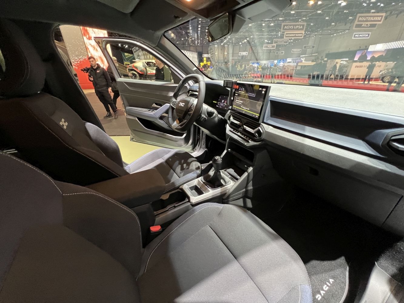 Modern car interior with touchscreen dashboard and manual transmission