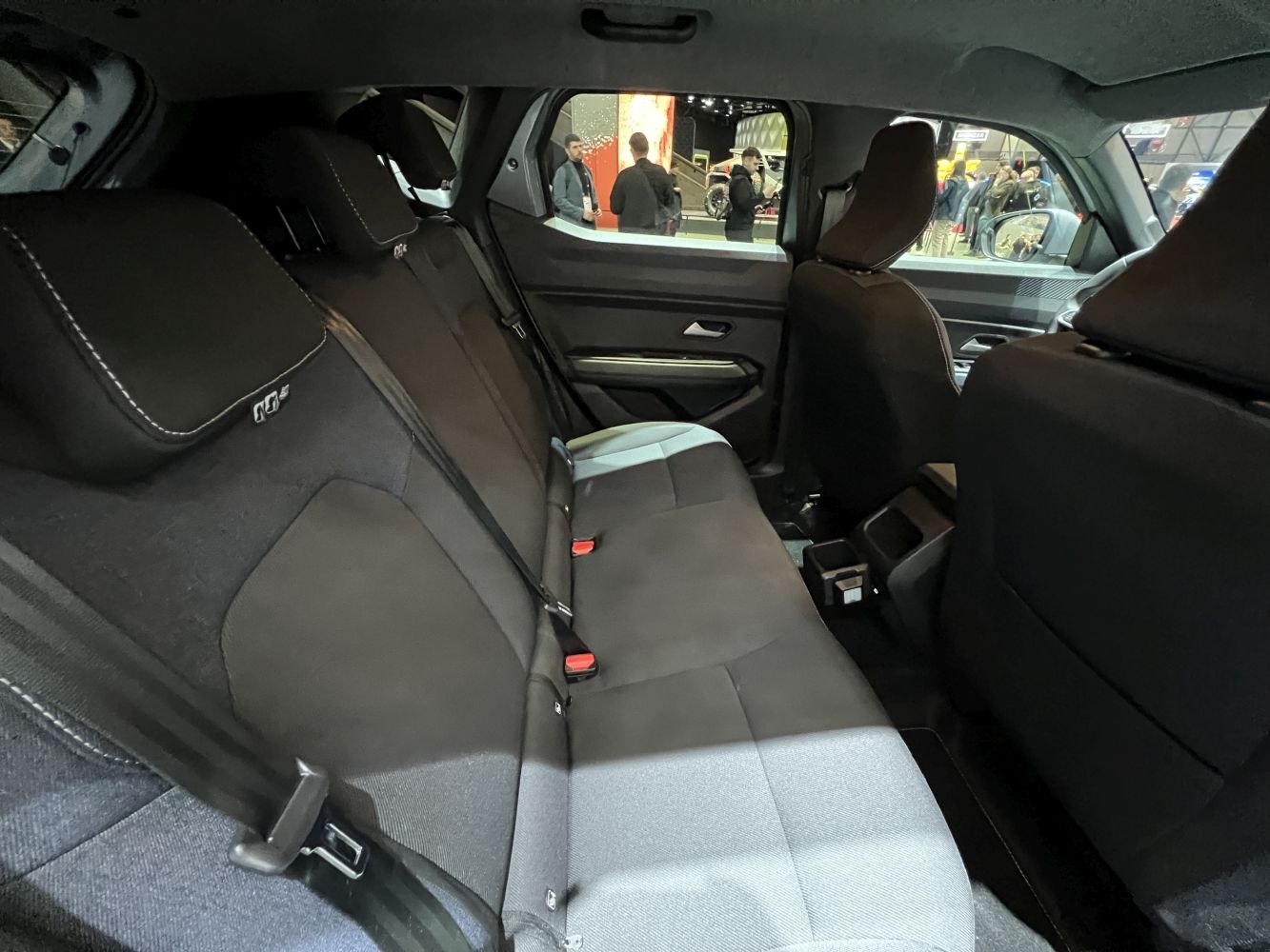 Rear seat interior with spacious seating and seatbelt setup
