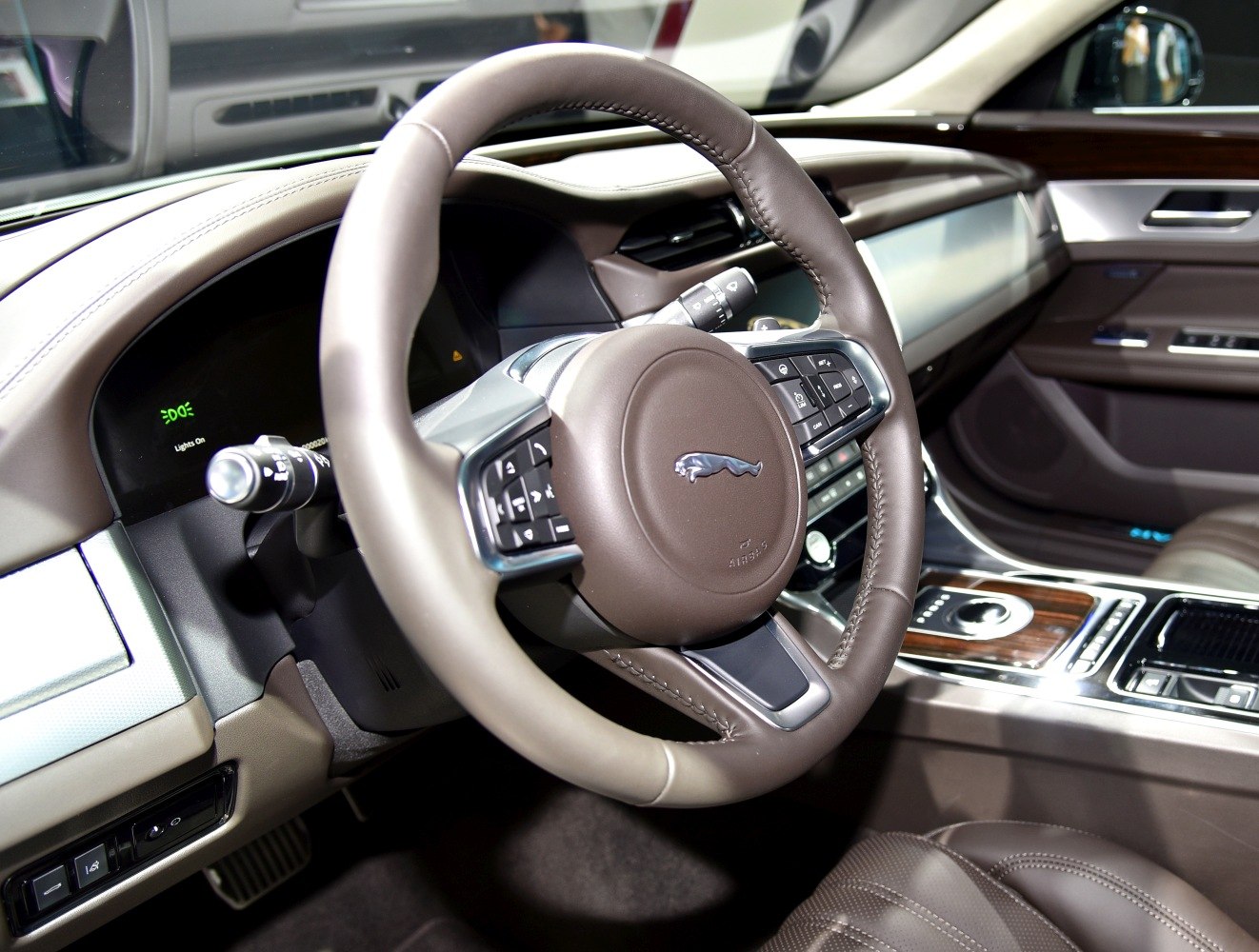 Steering wheel and dashboard controls in luxury car interior