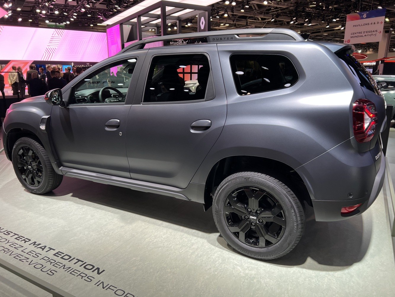 Matte-finish SUV side view with black alloy wheels and roof rails