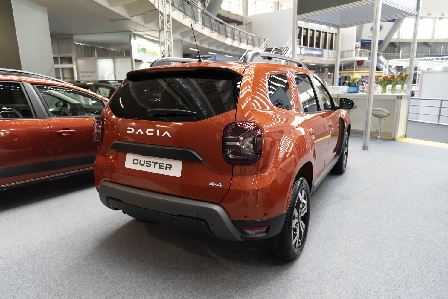 Rear view of an orange SUV with distinctive taillights and roof rails