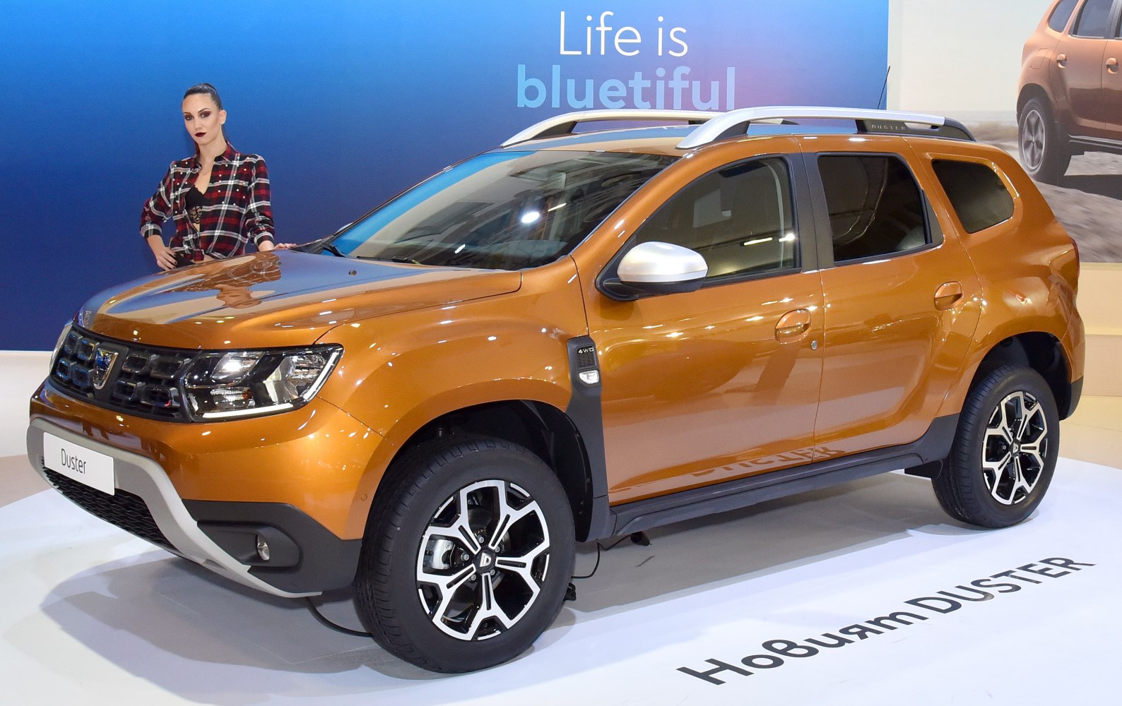 Metallic orange SUV with alloy wheels and roof rails
