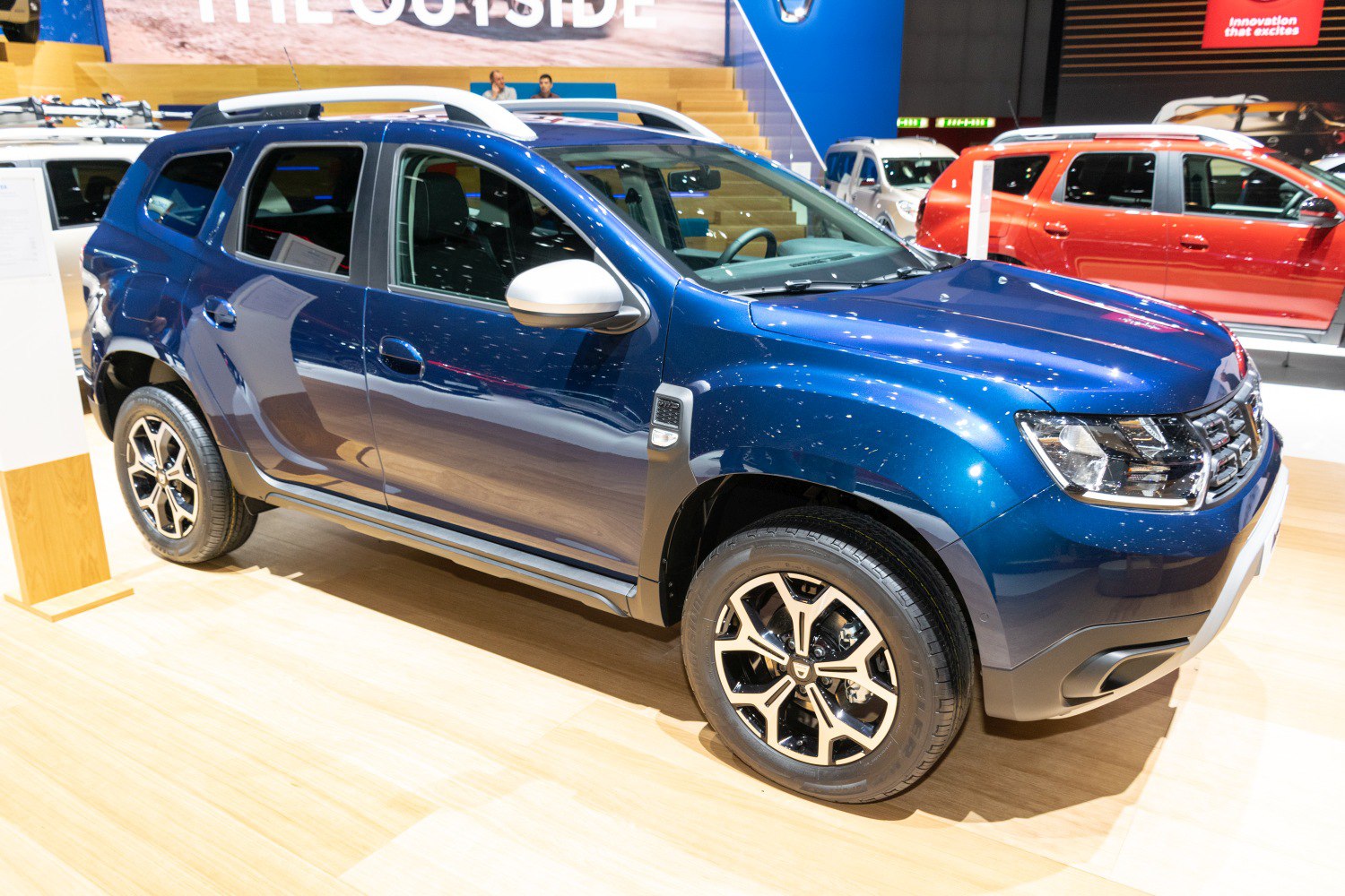 Blue SUV with alloy wheels and modern front grille