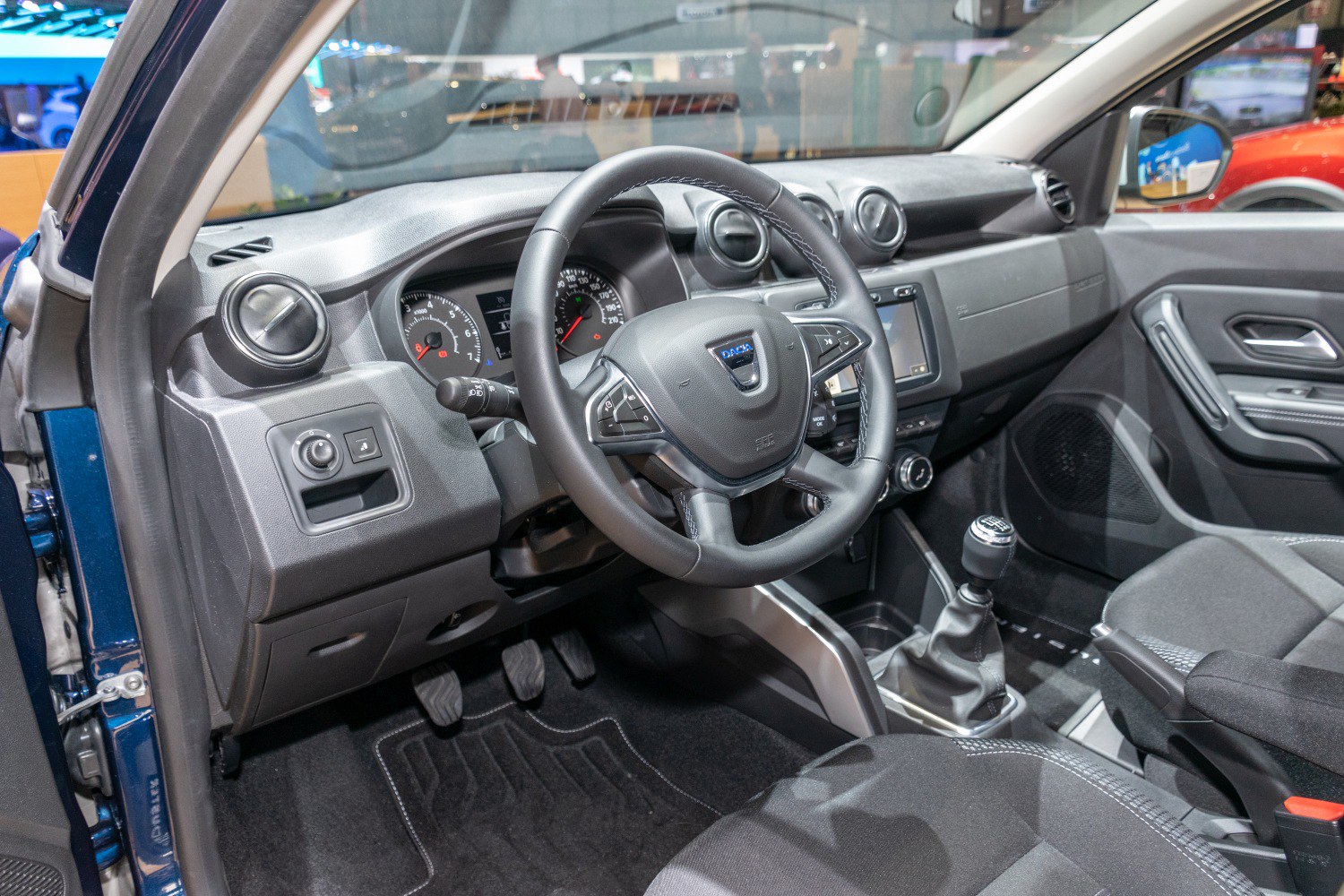 Interior dashboard, steering wheel, and manual gear shift view