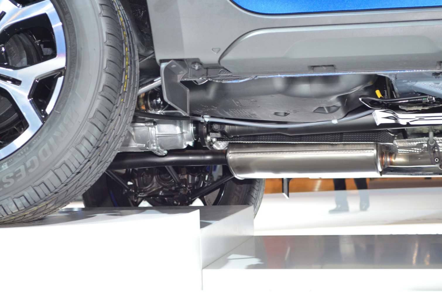 Rear suspension and exhaust system components under a vehicle
