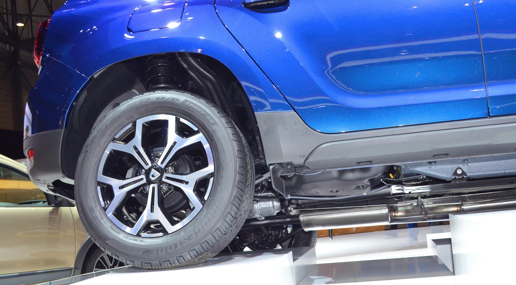 Close-up of rear wheel, suspension, and exhaust system