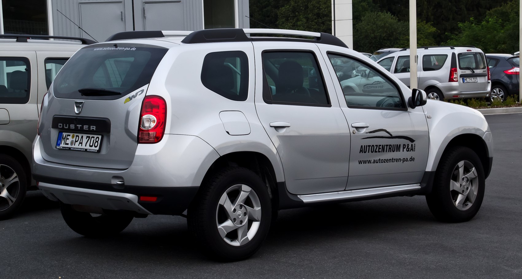 Silver 4WD SUV with roof rails and alloy wheels, side and rear view