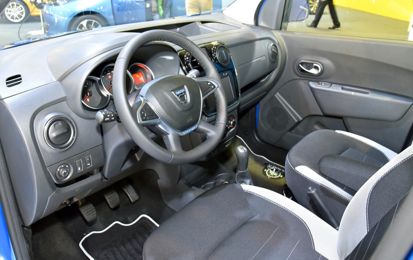 Interior view with dashboard, steering wheel, and front seats