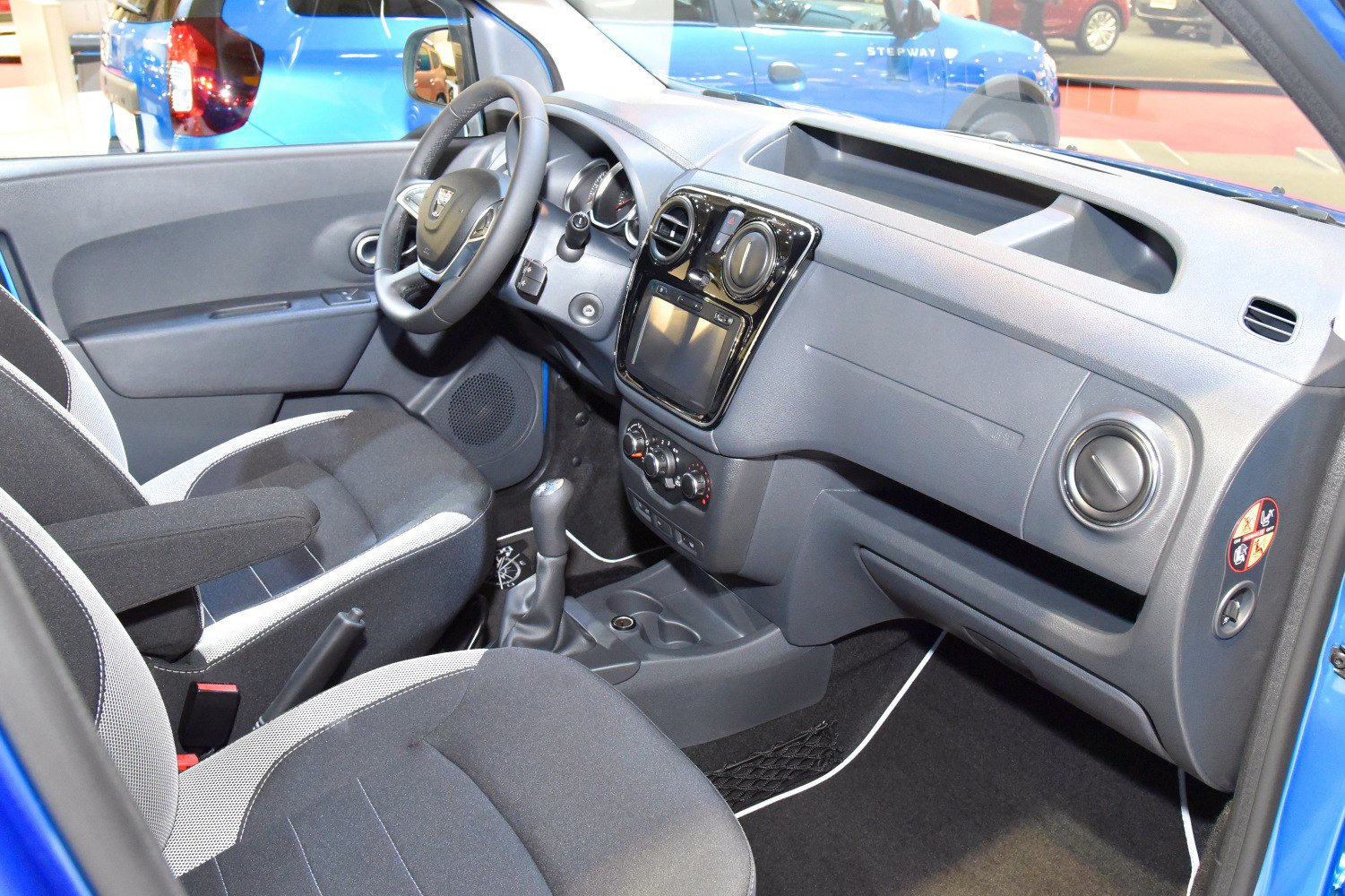 Dashboard, steering wheel, front seats, manual gearshift in vehicle interior
