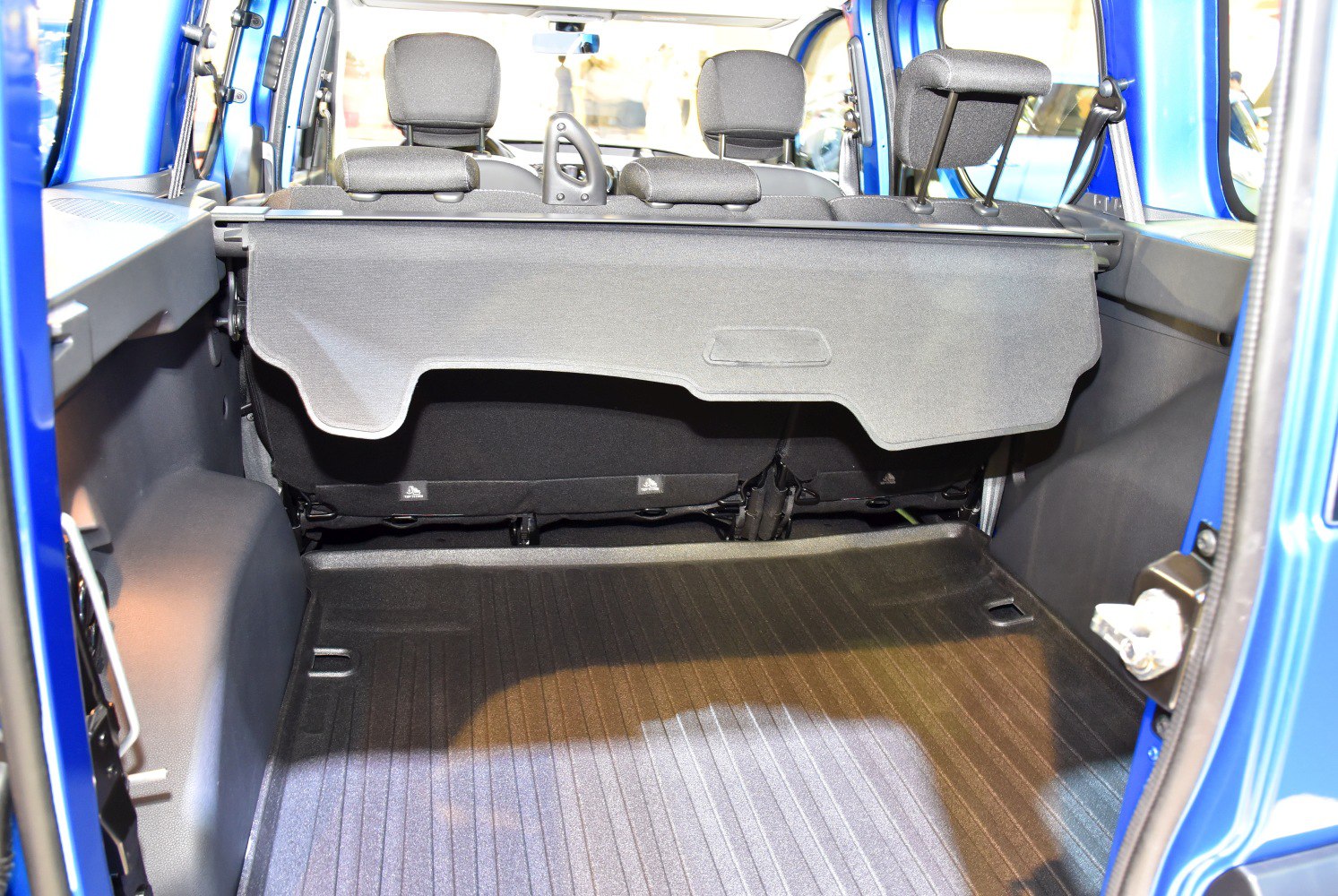 Rear cargo space with protective storage cover and visible rear seat headrests