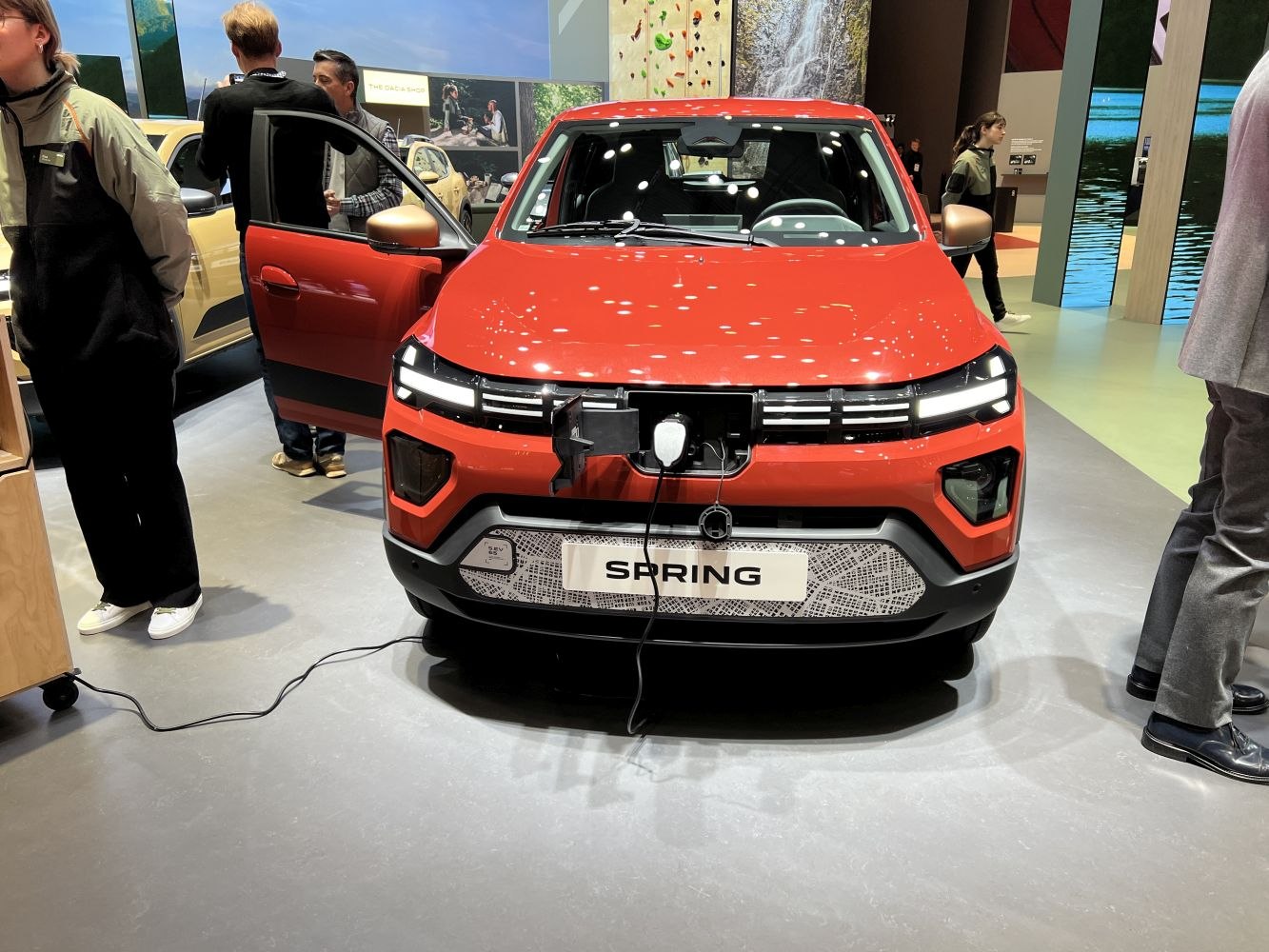 Front view of compact electric SUV charging with LED headlights