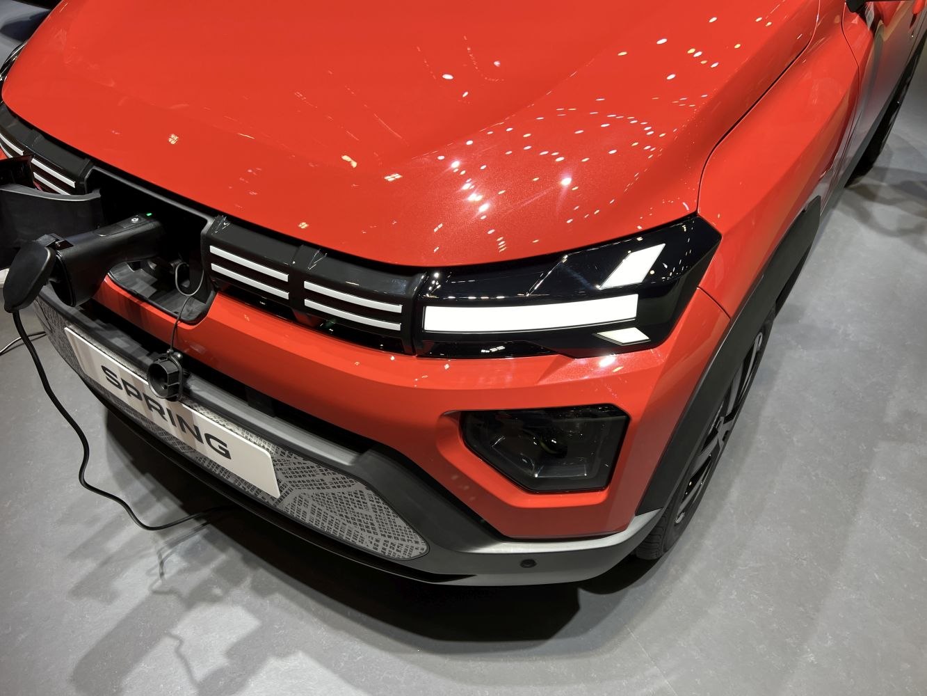 Electric vehicle front with charging port and LED headlights