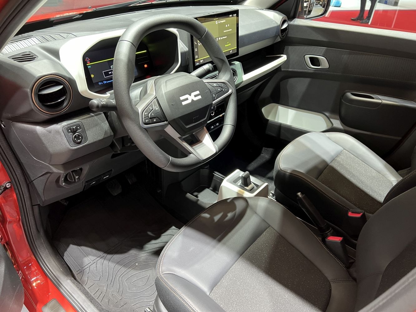 Digital instrument cluster and multifunction steering wheel in compact car interior