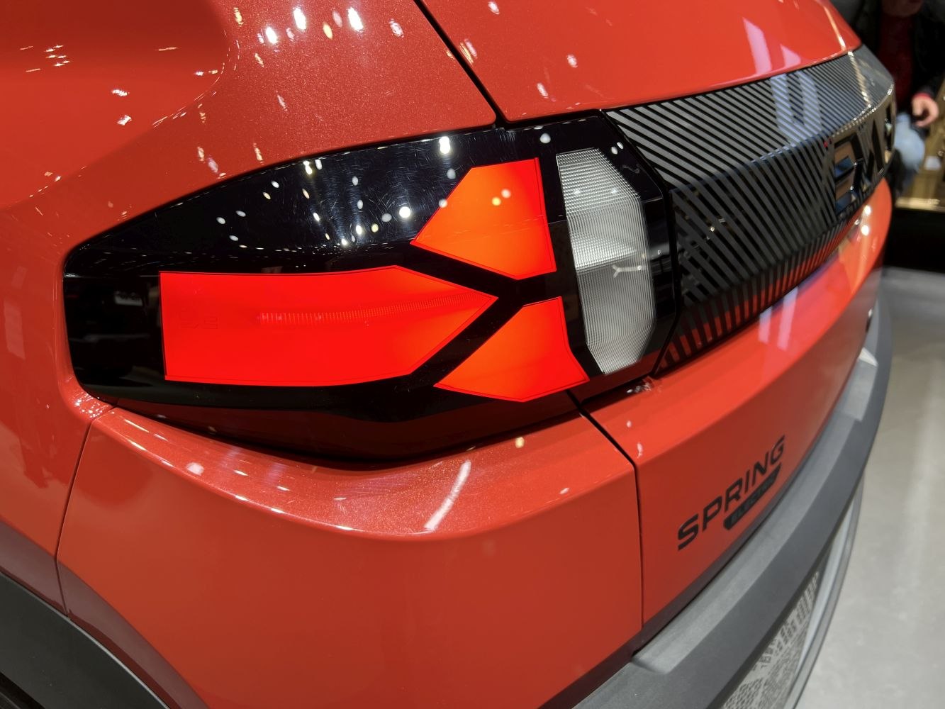 Close-up of rear LED tail light and badge on facelift electric hatchback