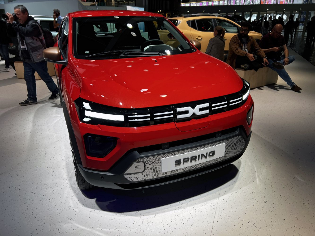 Front view of red compact SUV with LED headlights and modern grille