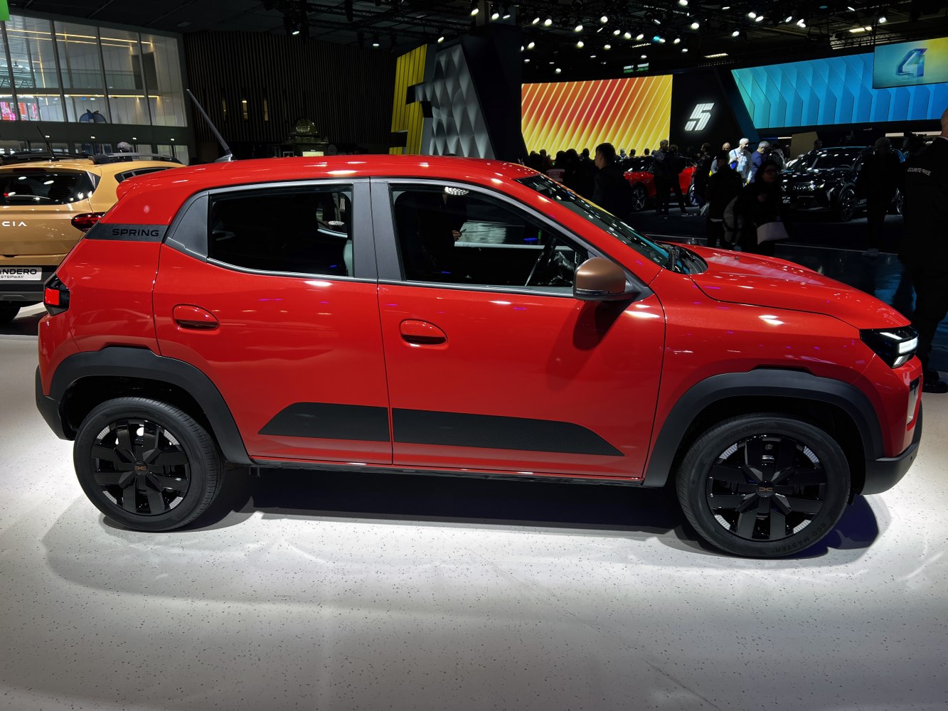 Red SUV side profile with black accents and modern rims