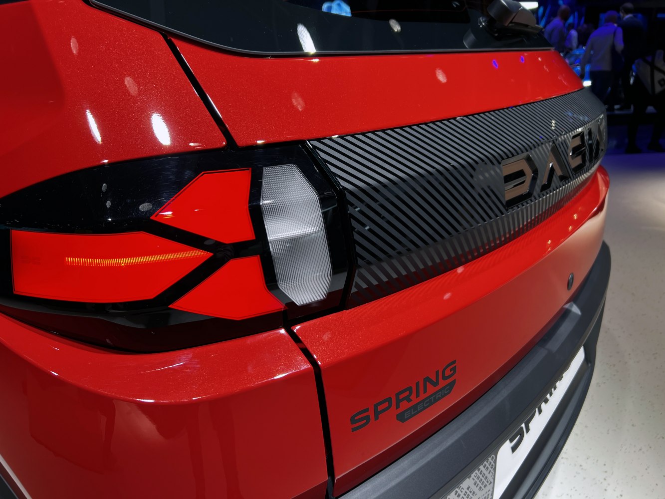 Close-up of modern rear taillight and rear panel design with emblem.