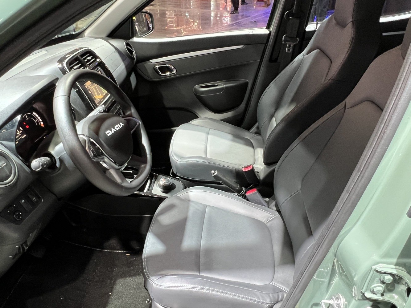 Front seats and dashboard with steering wheel and touchscreen