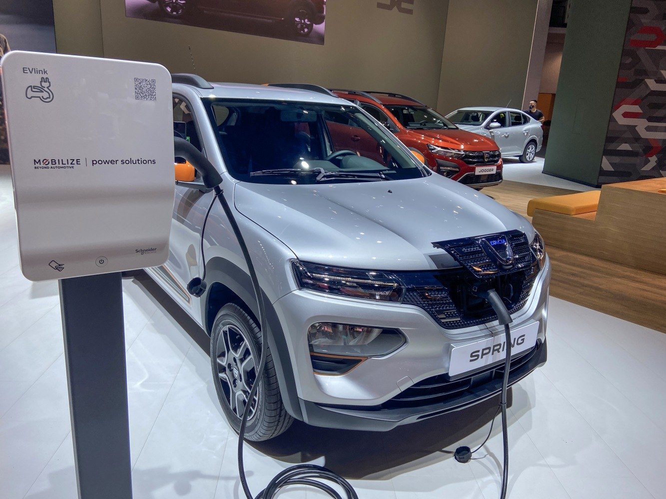 Electric vehicle front view charging at auto show