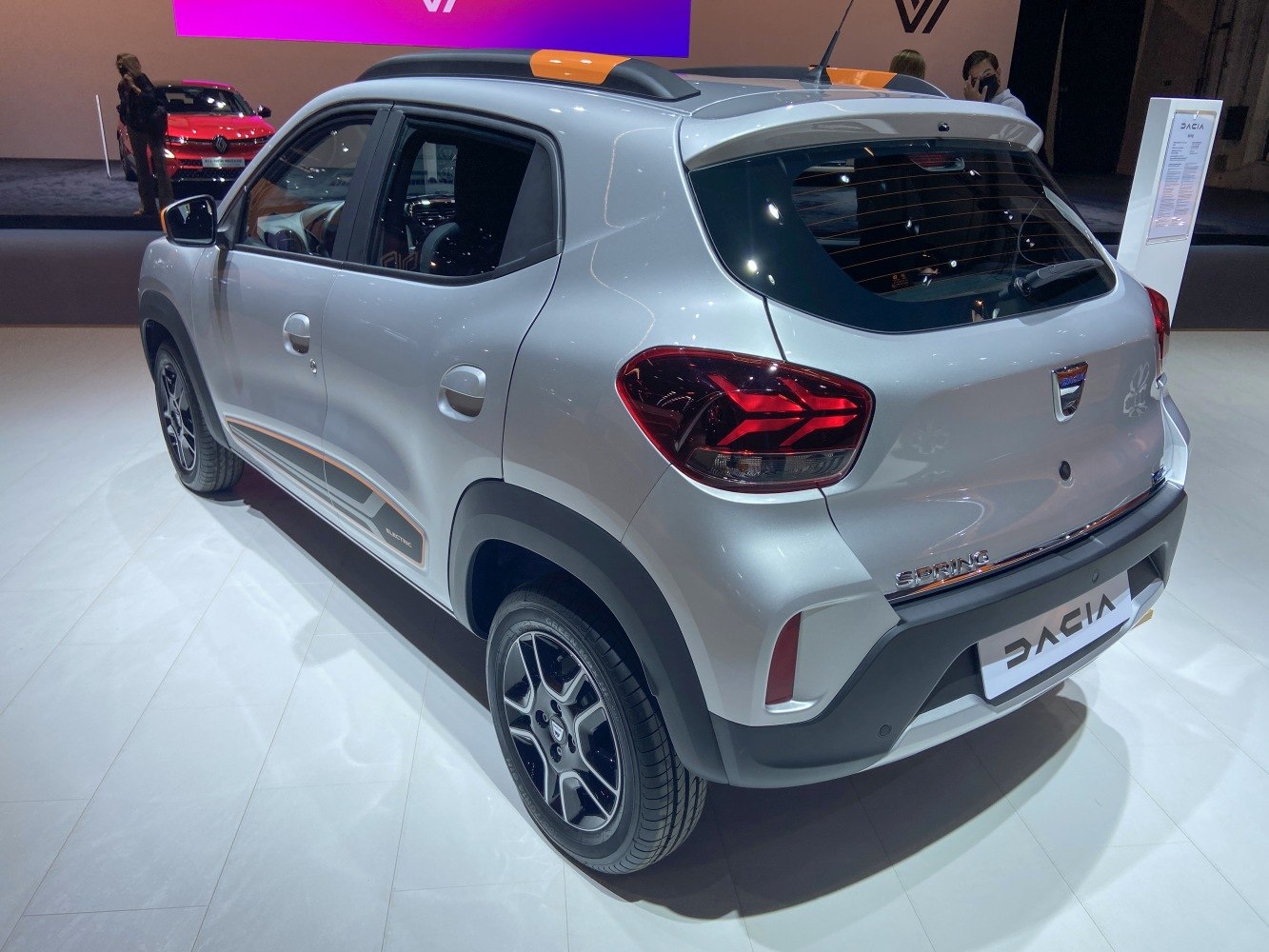 Compact electric SUV rear view with tail lights, roof rails, and body decals