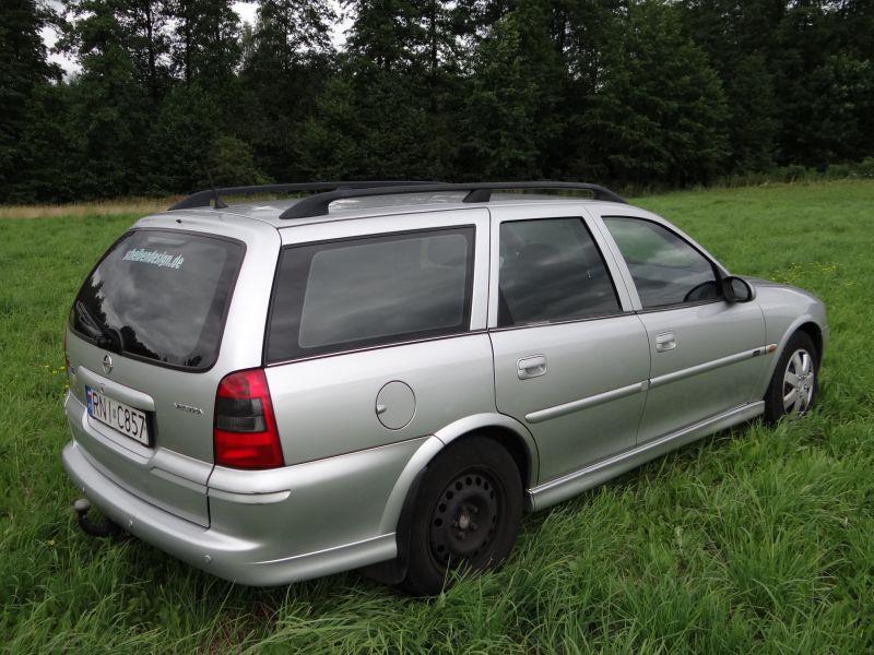 Silver station wagon rear and side view with roof rails and tinted windows