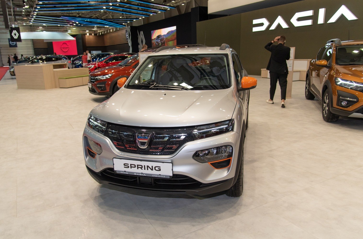 Front view of electric SUV with orange accents and LED headlights
