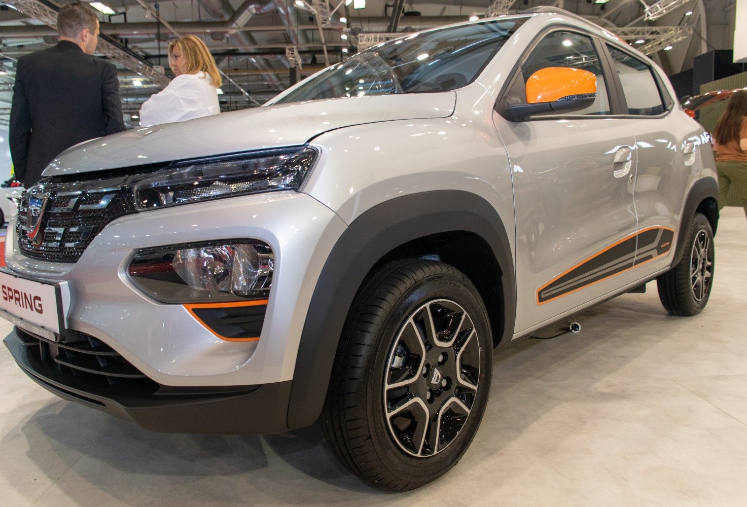 Front fender, headlight, and alloy wheel design with black and orange trim