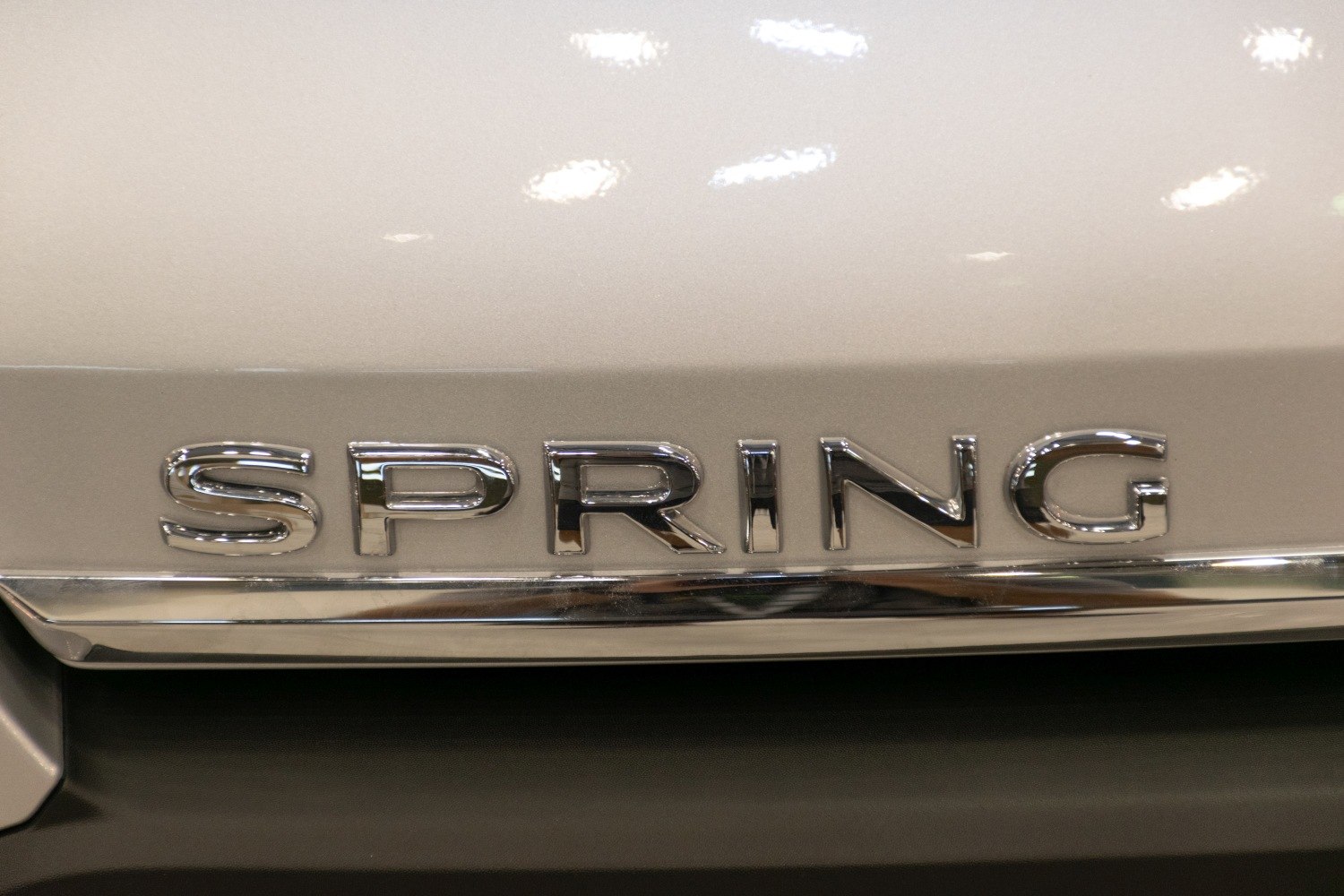 Close-up of chrome SPRING emblem badge on vehicle exterior