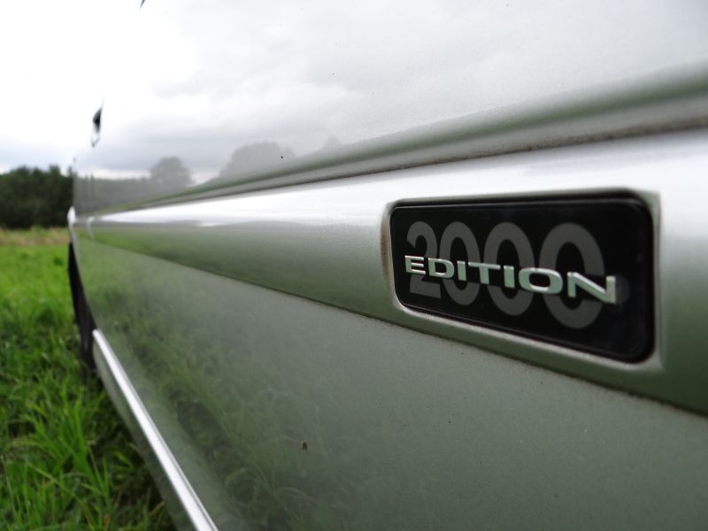 Close-up of 2000 Edition side badge on silver car body