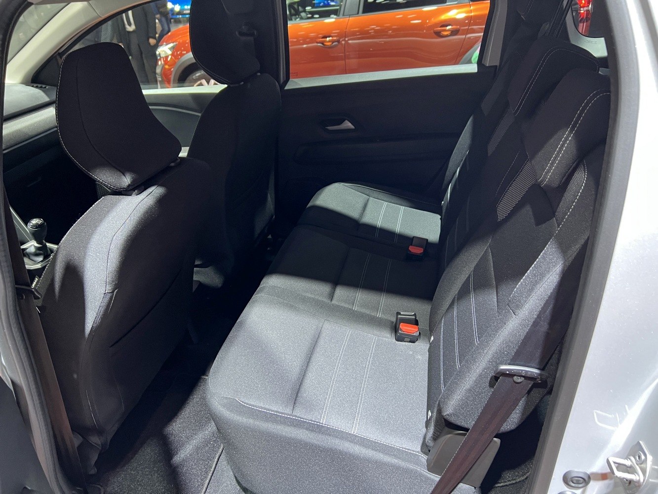 Rear seating with fabric upholstery and integrated seatbelts