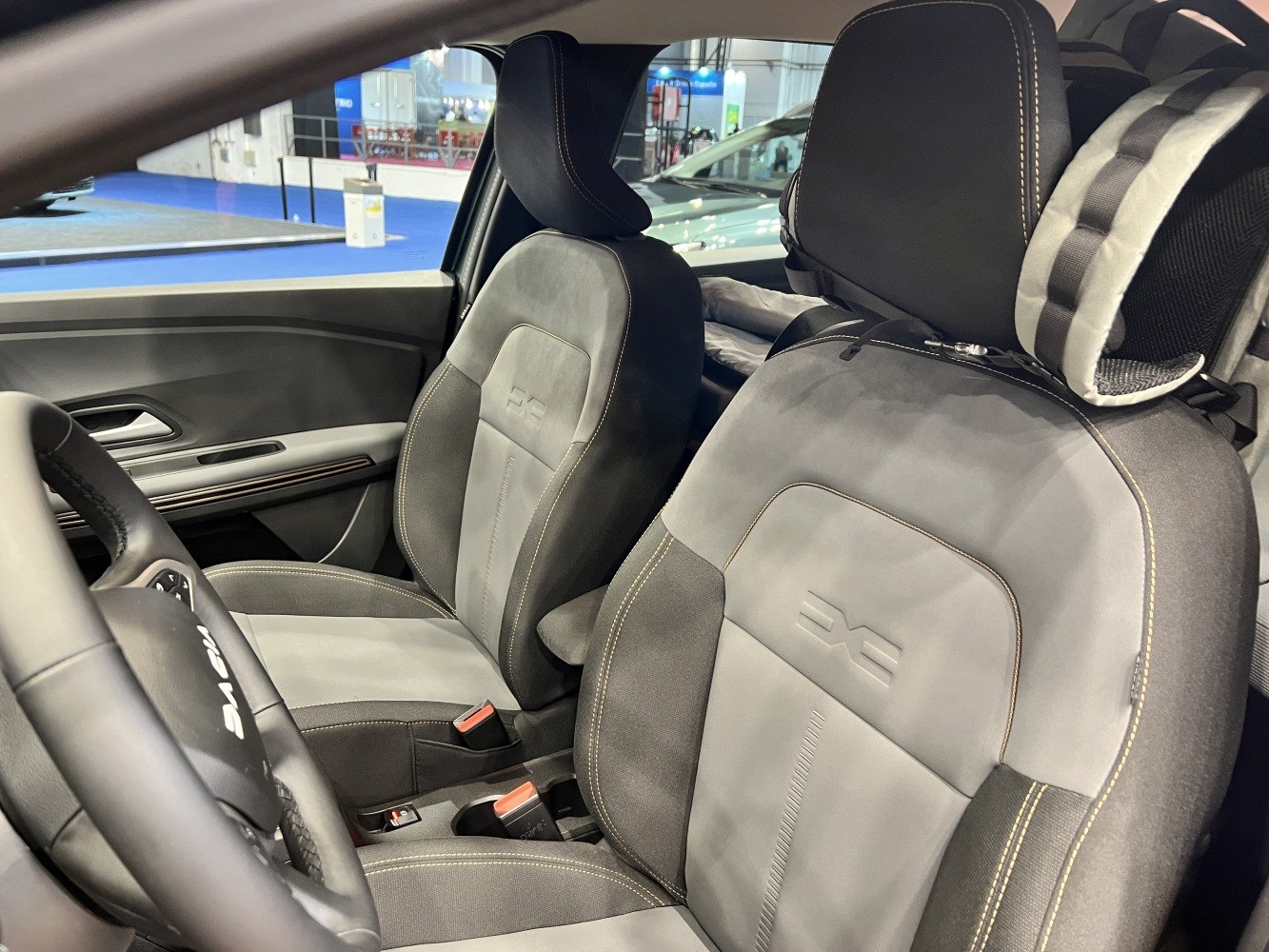 Two-tone ergonomic front seats with detailed stitching and headrests in a modern car interior.