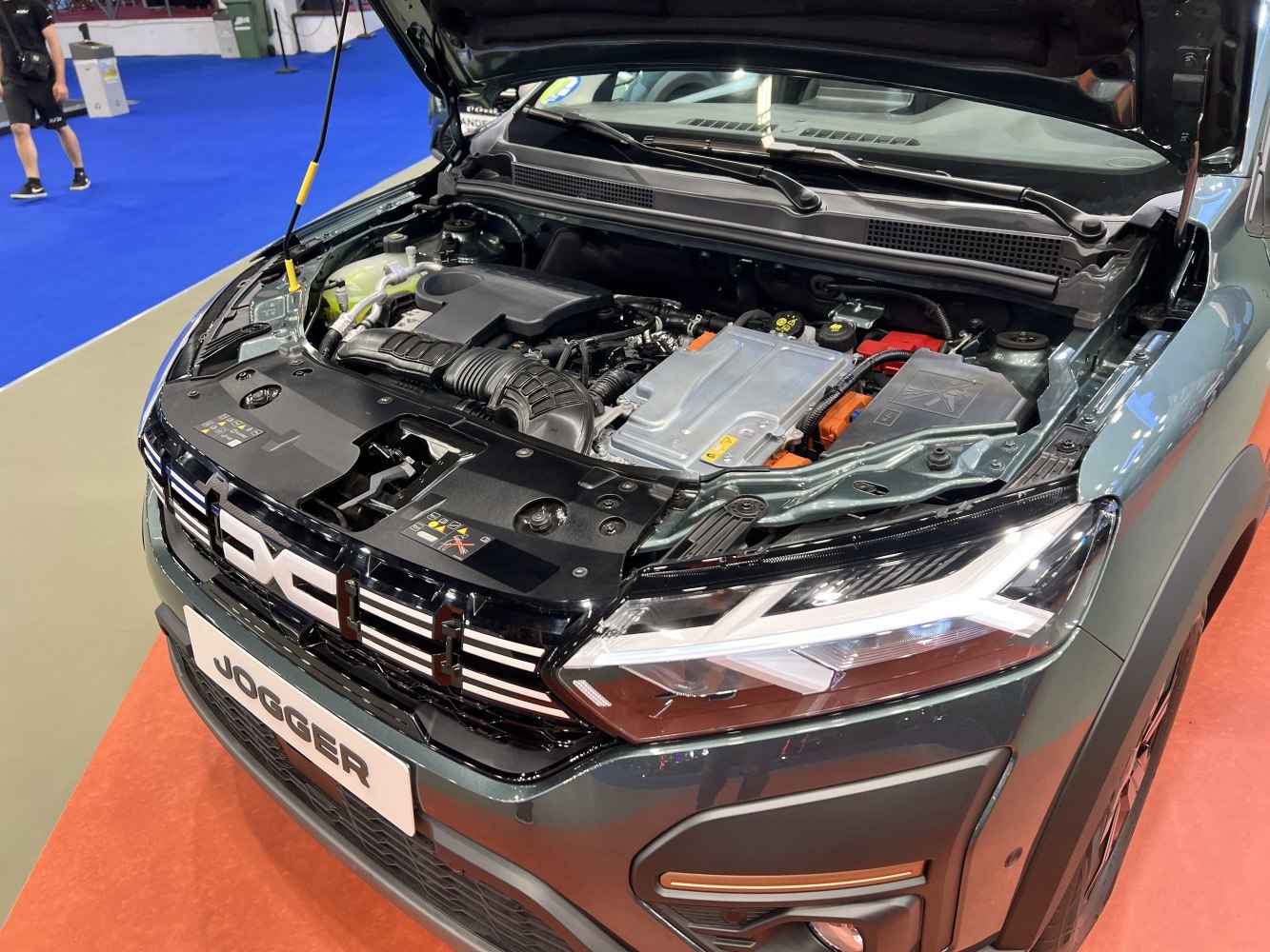 Open engine bay and modern front headlight design with hybrid motor components