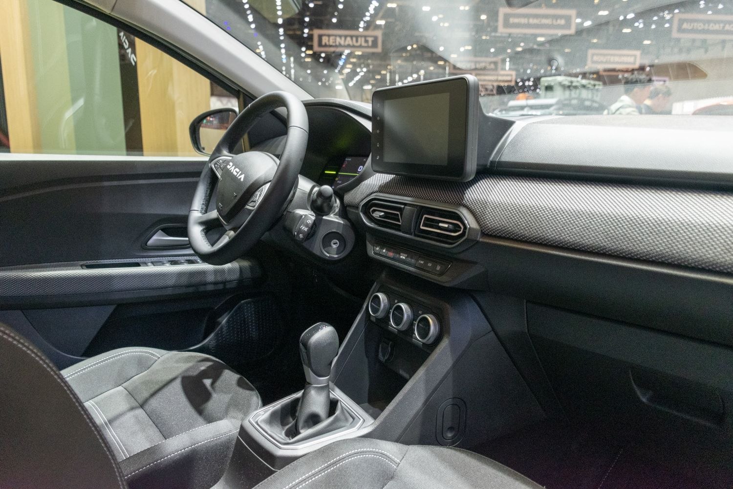 Modern car interior with digital display and ergonomic steering wheel