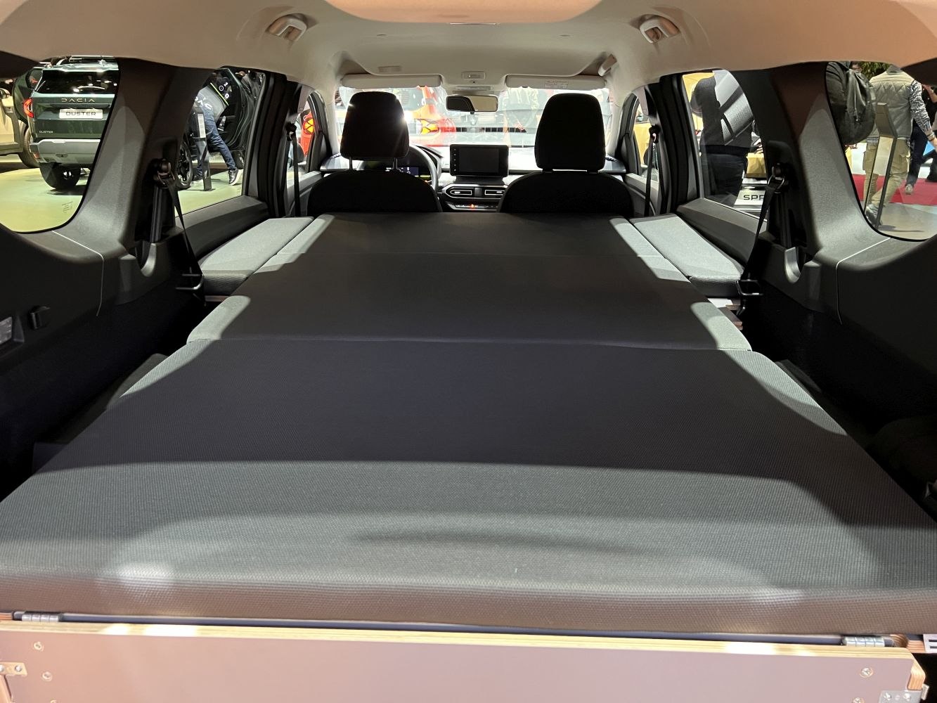 Folded rear seats creating flat and spacious cargo area inside the vehicle.