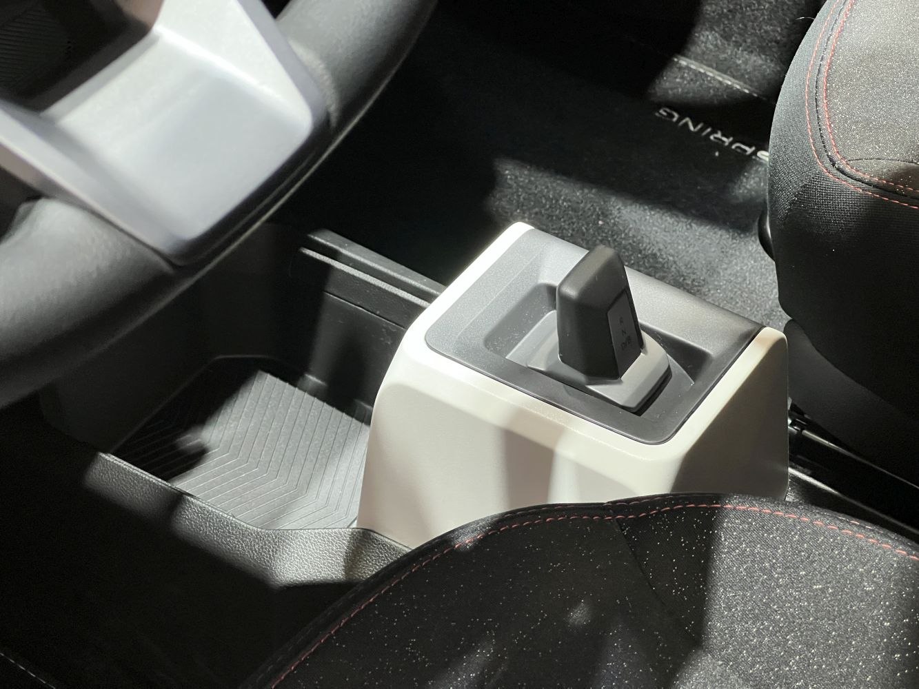 Compact center console with unique gear selector and ergonomic design