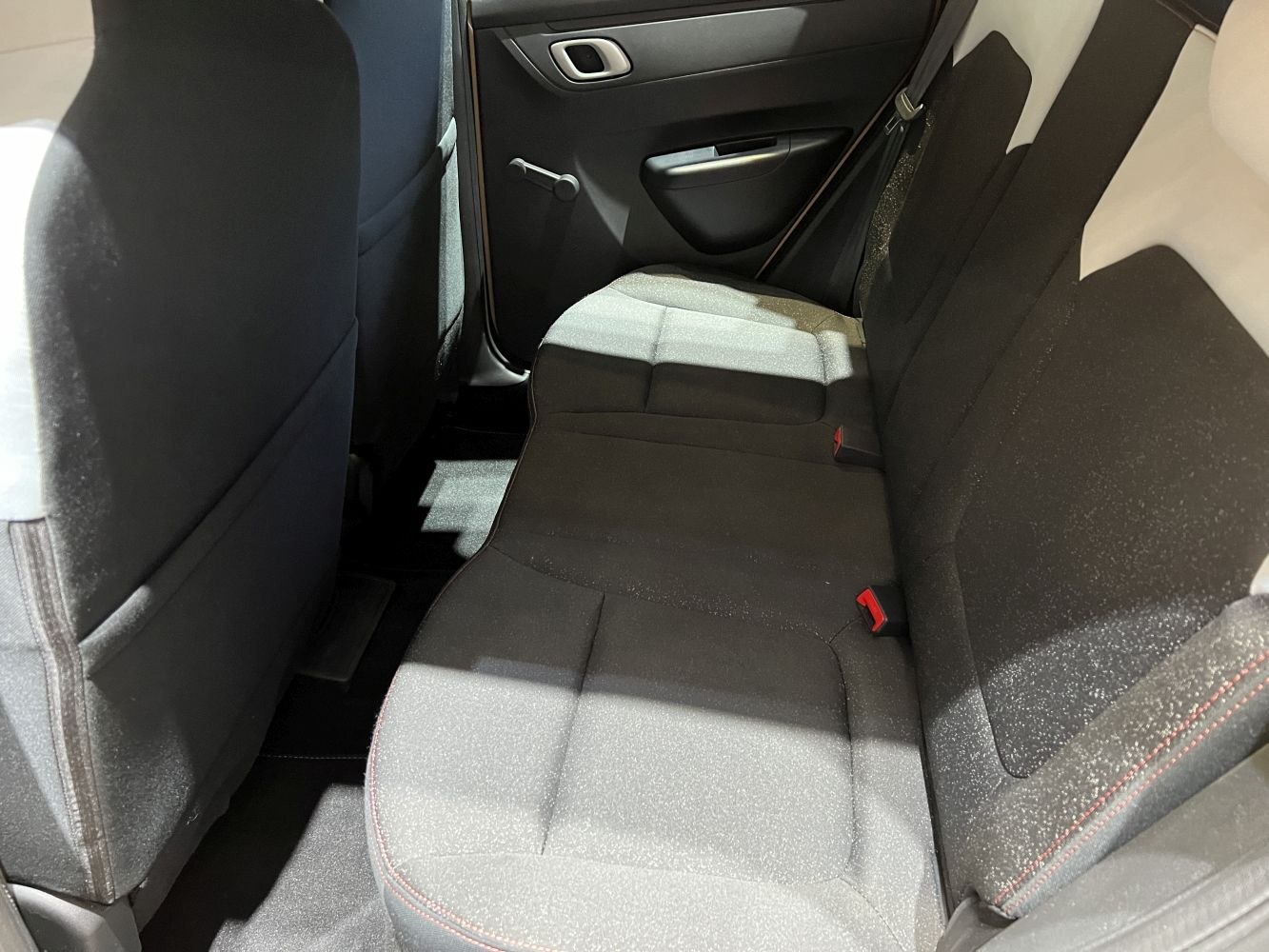 Rear fabric seats and interior door panel with manual window crank