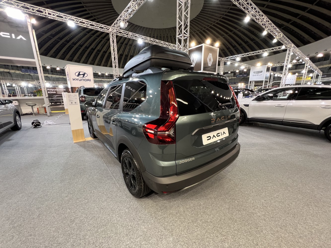 Rear view of car with roof cargo box and distinctive taillights