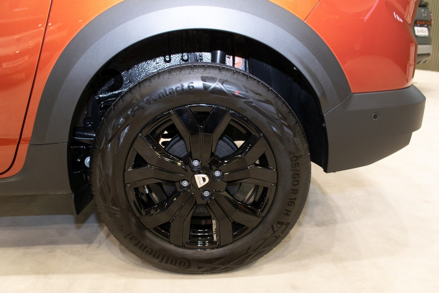 Black alloy wheel with Continental EcoContact 6 tire and visible suspension
