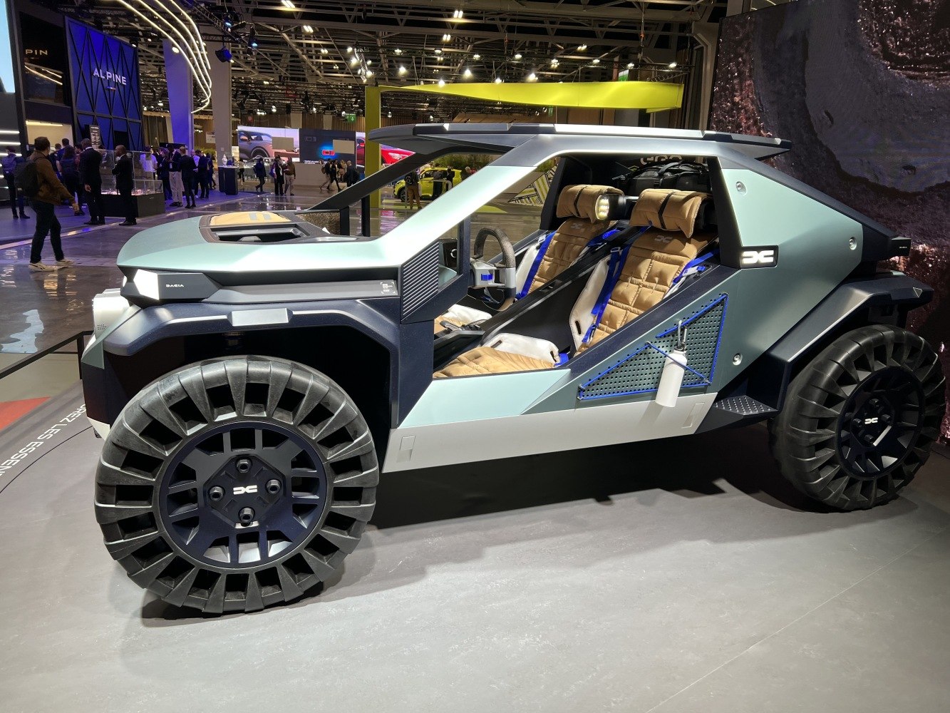 Open frame SUV design with unique rugged wheels and visible interior details