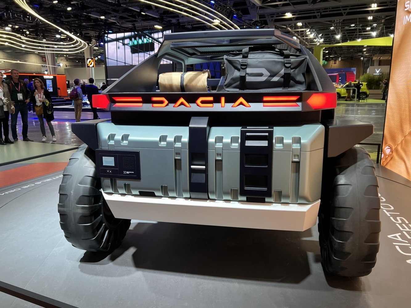 Rear view with rugged tires, illuminated brand name, and storage compartments