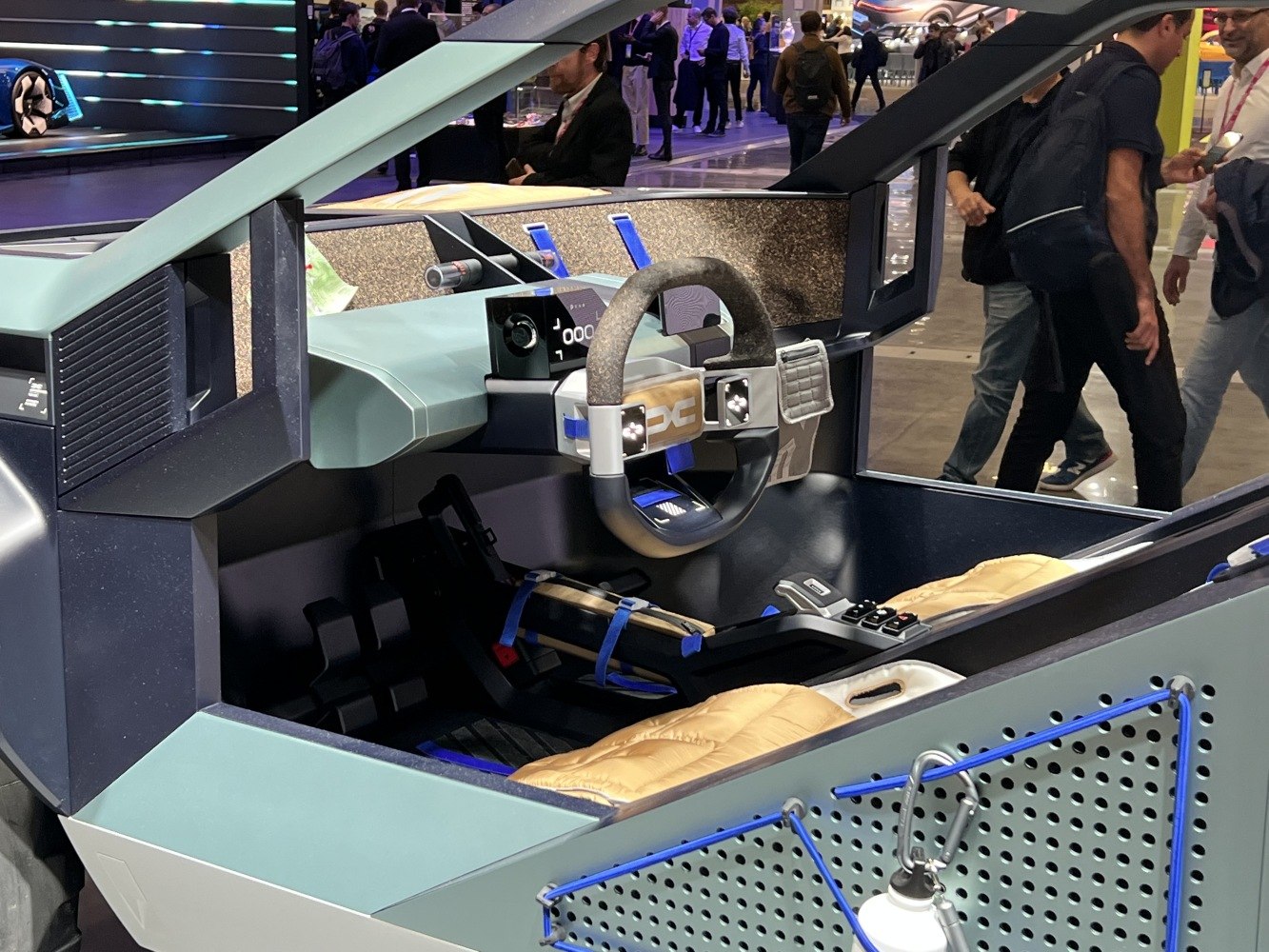 Futuristic car interior with unique steering wheel and dashboard.
