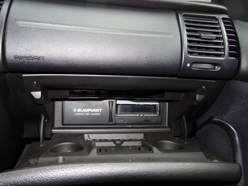 Close-up of Blaupunkt compact disc changer inside car glovebox