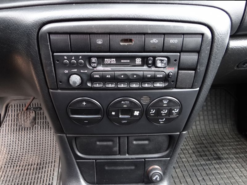 Car radio and climate control panel with buttons and dials