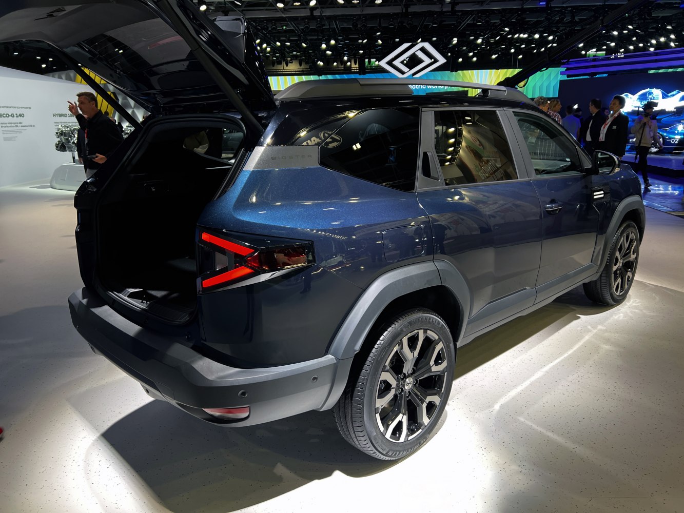 Rear and side view of SUV with open trunk and modern taillights